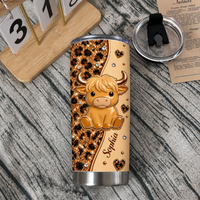 A personalized stainless steel cup next to a calendar block and open lid on a wooden desk.