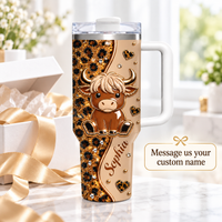 A 40oz custom name tumbler with a handle standing next to a gift box, featuring a baby highland cow and leopard print.