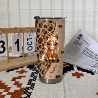 Personalized horse tumbler with cute pony and leopard print standing on woven mat beside calendar block and newspaper.