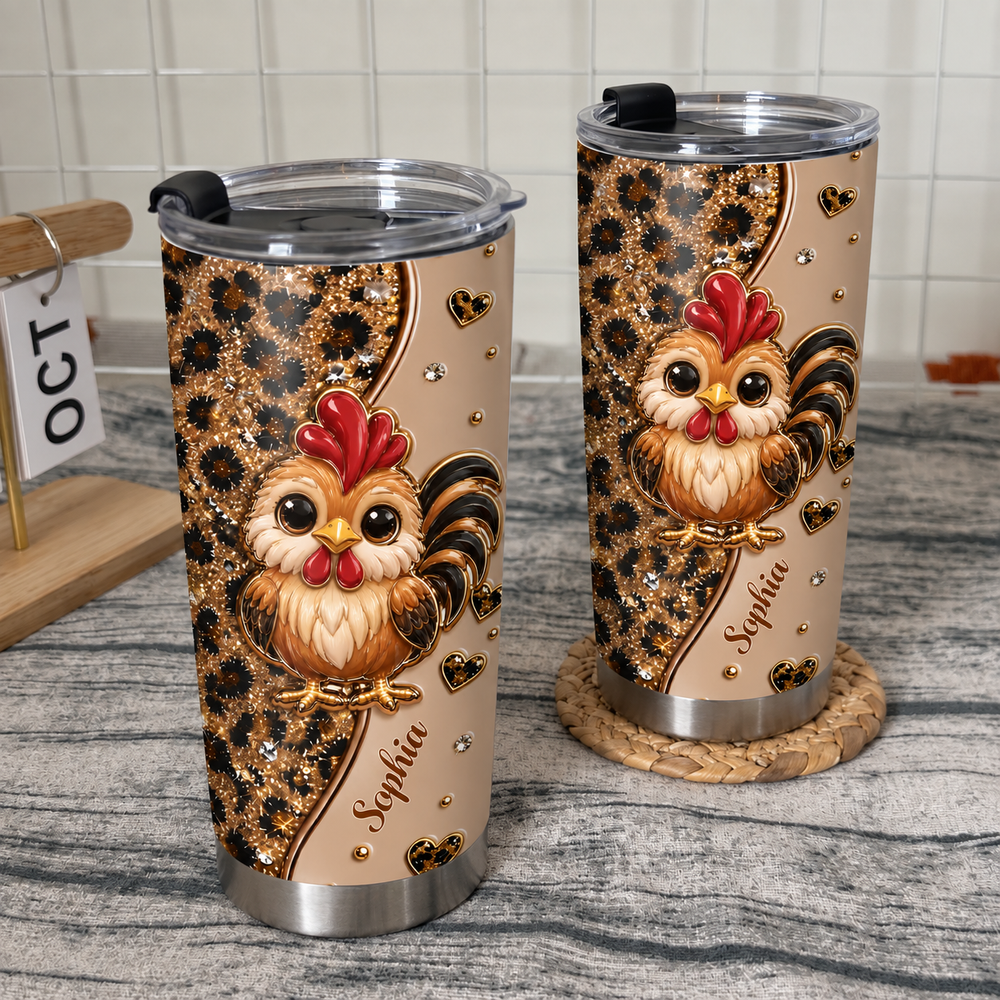 Two personalized chicken cups with leopard print and cute roosters on a textured gray countertop near a white wire rack.