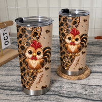 Two personalized chicken cups with leopard print and cute roosters on a textured gray countertop near a white wire rack.