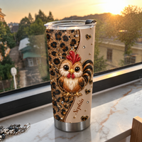 A personalized chicken cup with a cute rooster and leopard print resting on a marble windowsill at sunset.