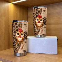 Two personalized chicken cups with leopard print and cute roosters standing inside a wooden cabinet shelf.