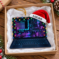 Acrylic laptop ornament packed inside a cardboard gift box lined with white tissue paper.