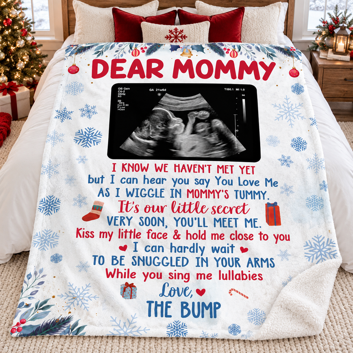Folded white Sherpa fleece pregnancy announcement blanket displayed neatly on a white bed with pillows.