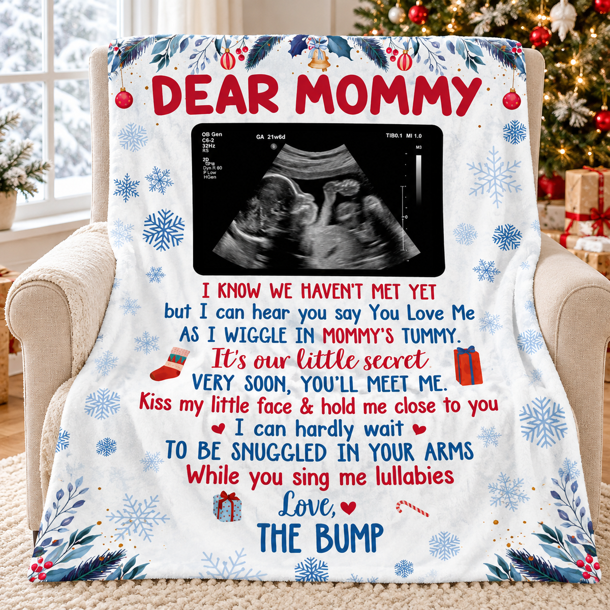 White flannel blanket featuring a baby ultrasound and holiday poem draped over an armchair.