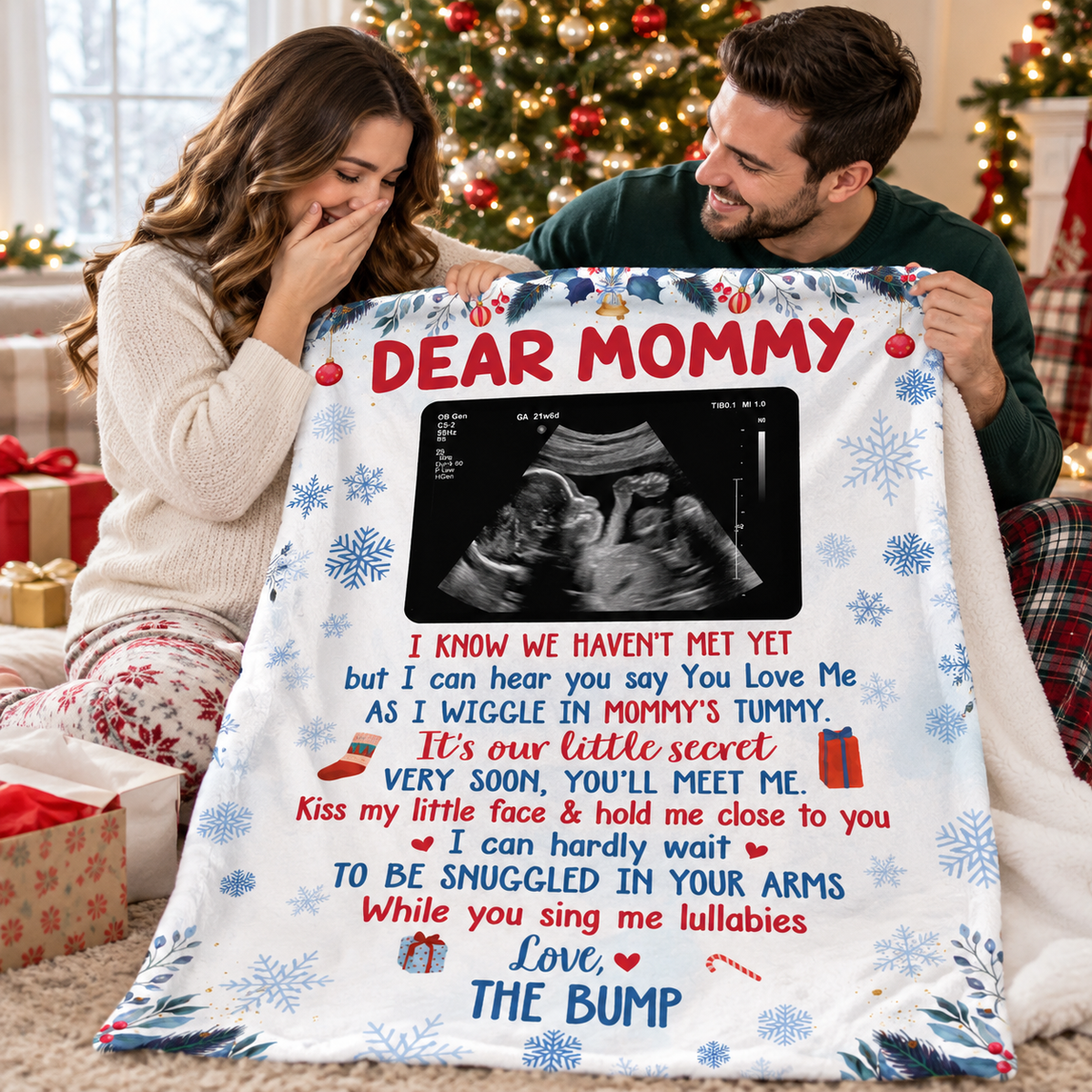 Expecting parents smiling while holding a custom ultrasound pregnancy announcement blanket in a festive room.