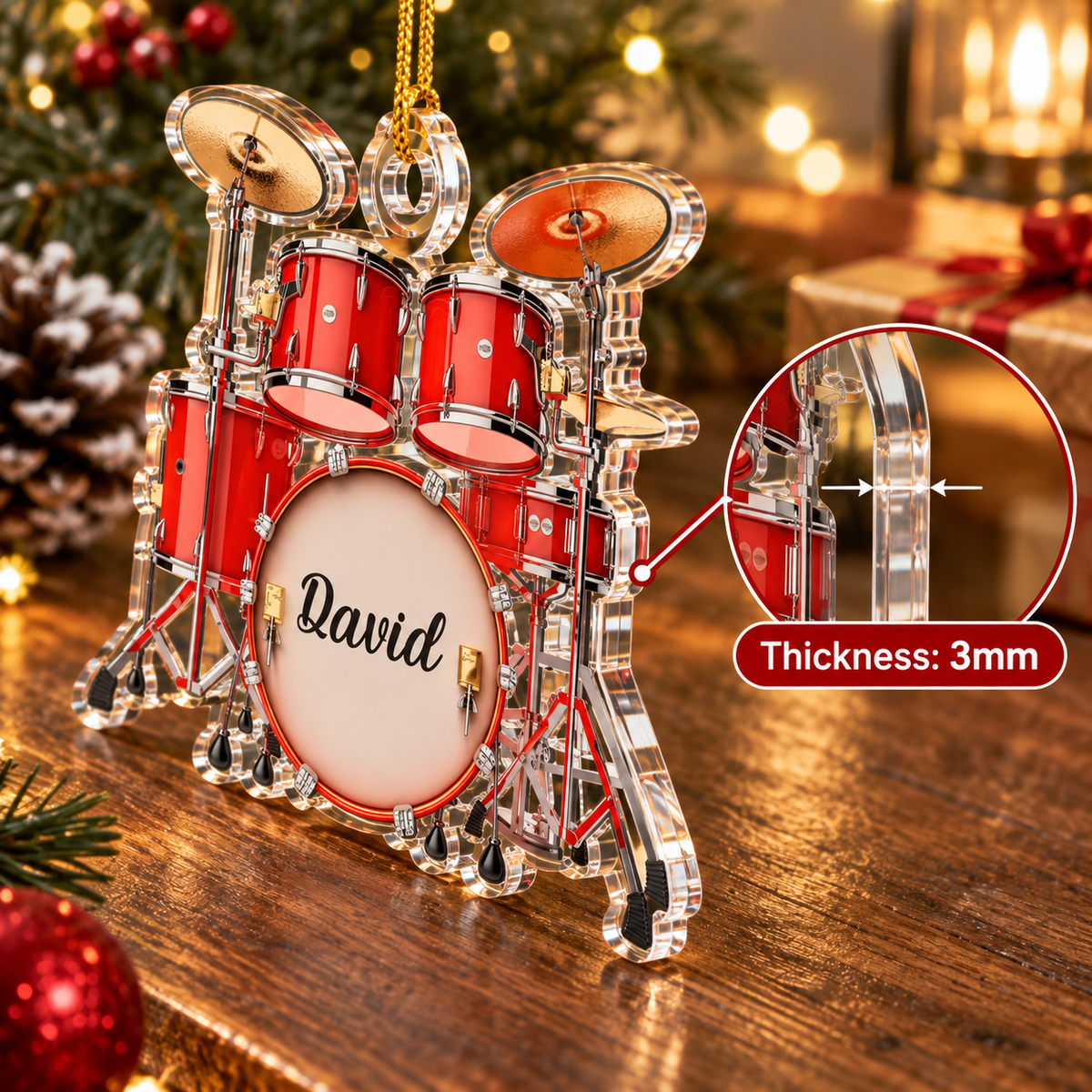 Side profile view of the flat acrylic drum set Christmas ornament showing its 3mm thickness on a wooden table with pinecones.