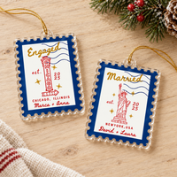 Two personalized acrylic Christmas ornaments resting on a wooden tabletop.