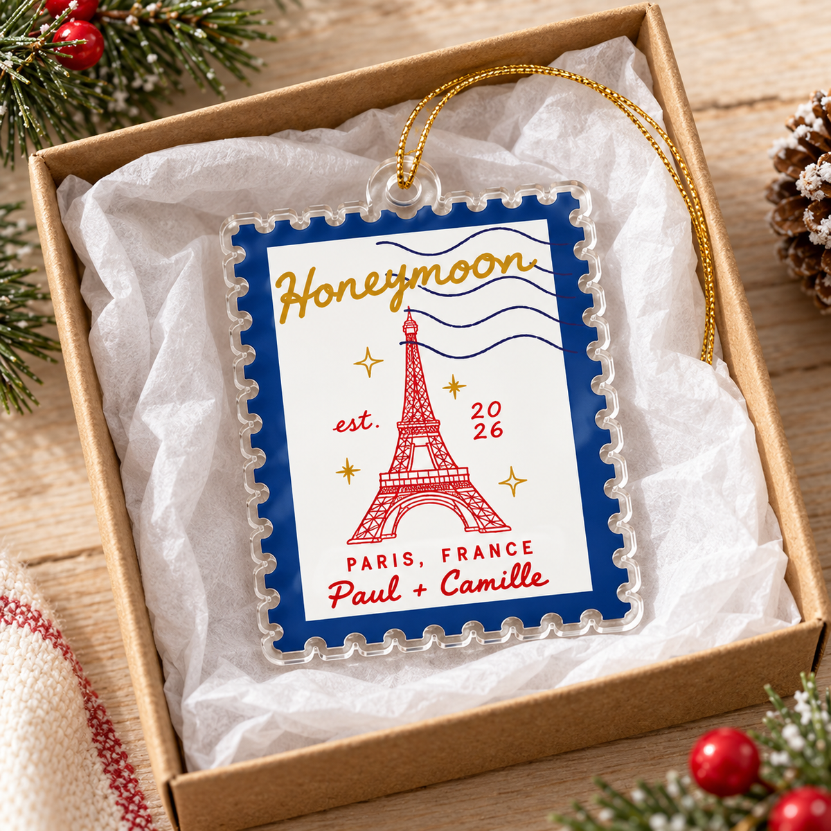 Honeymoon travel ornament inside an open gift box with tissue paper.
