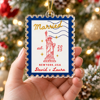 Hand holding a personalized New York wedding acrylic ornament.