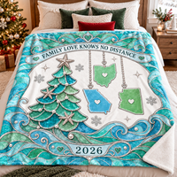 Personalized family blanket draped neatly on a made bed with holiday pillows and a glowing Christmas tree beside it.