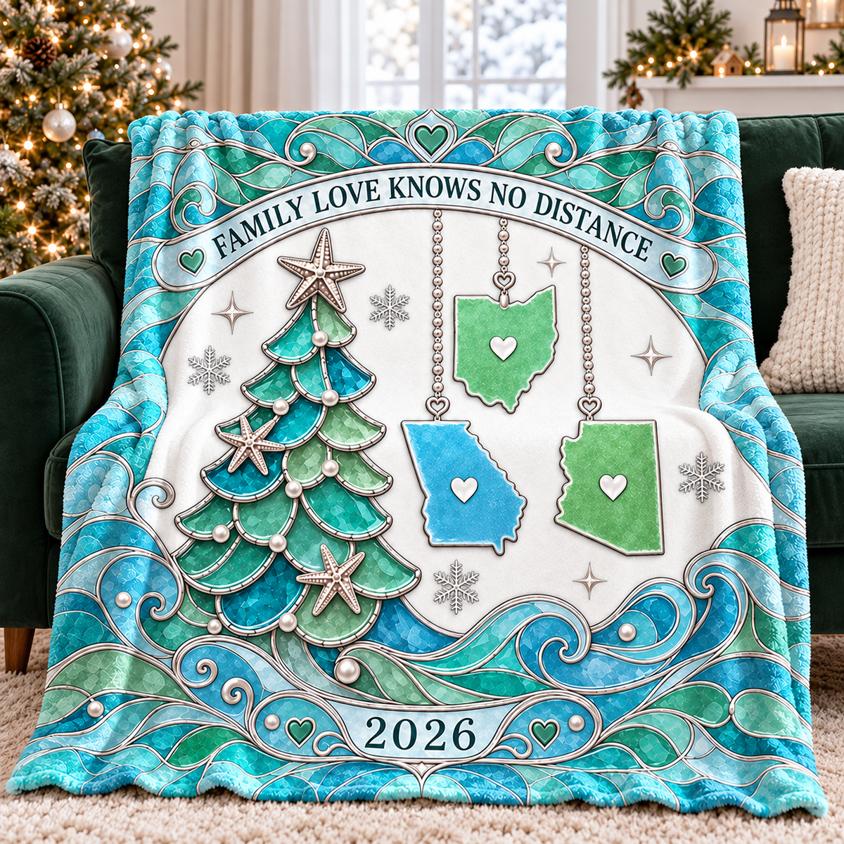Family Love Knows No Distance blanket draped on a green couch, featuring a teal Christmas tree, hanging state ornaments, and