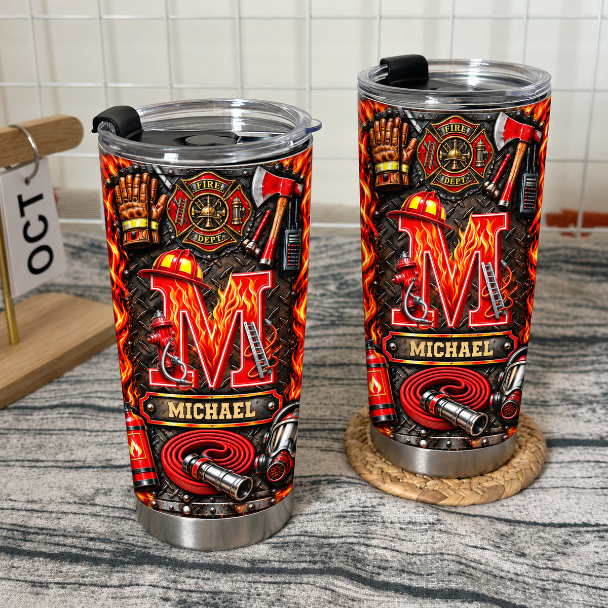 Two custom firefighter tumblers with distinct variations set on a wire rack shelf.