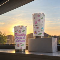 Two floral stainless steel cups standing on a windowsill at sunset, showcasing a best friend gift from another state.