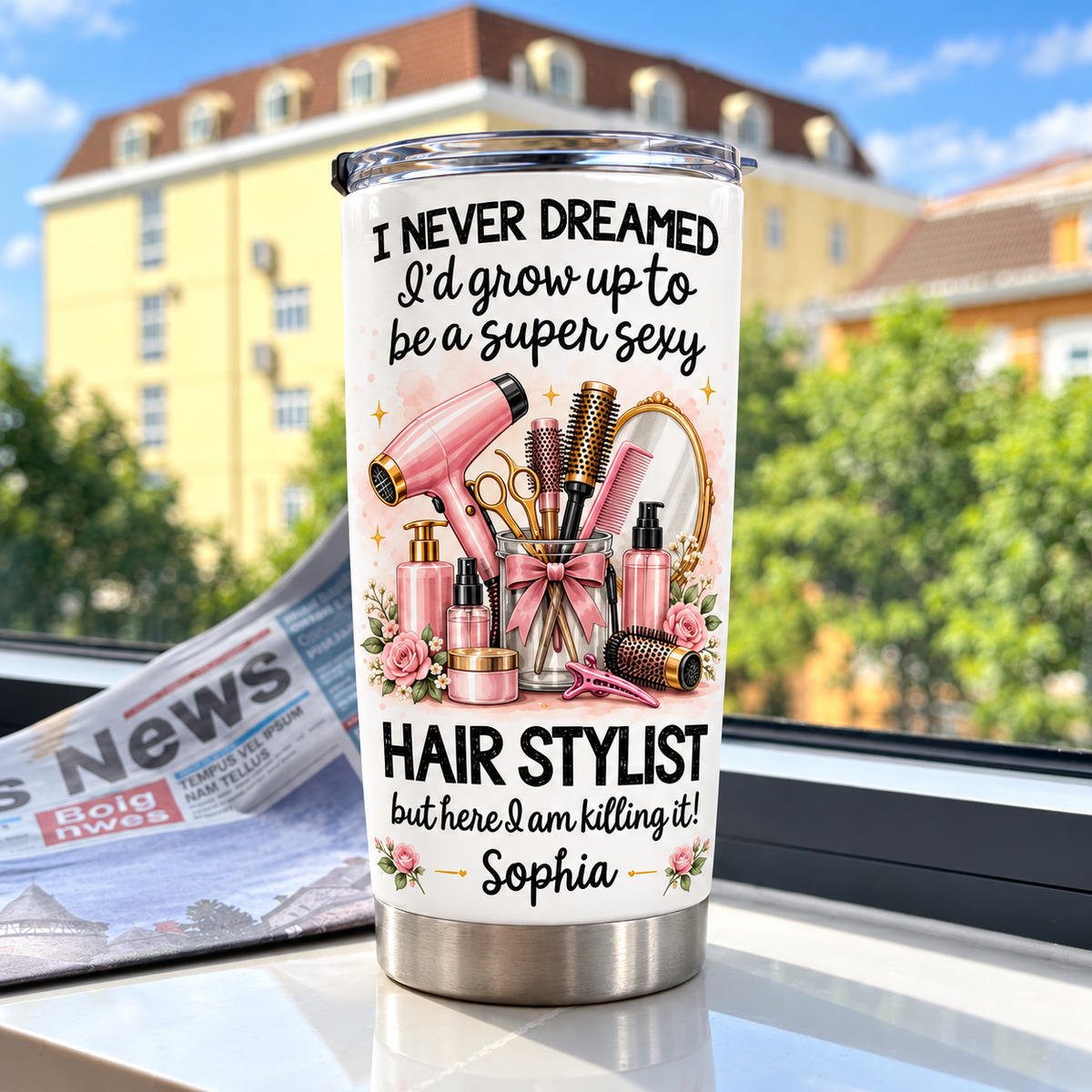 Personalized funny hairstylist tumbler resting on a white surface near a window with a newspaper and distant buildings.