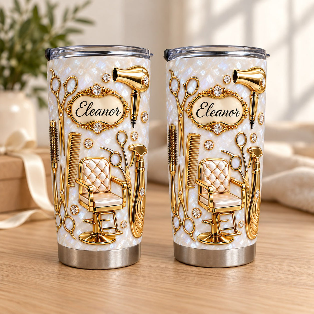 Two Gold Hairdresser Tools Tumblers stand side-by-side on a wooden surface with a soft-focus background.