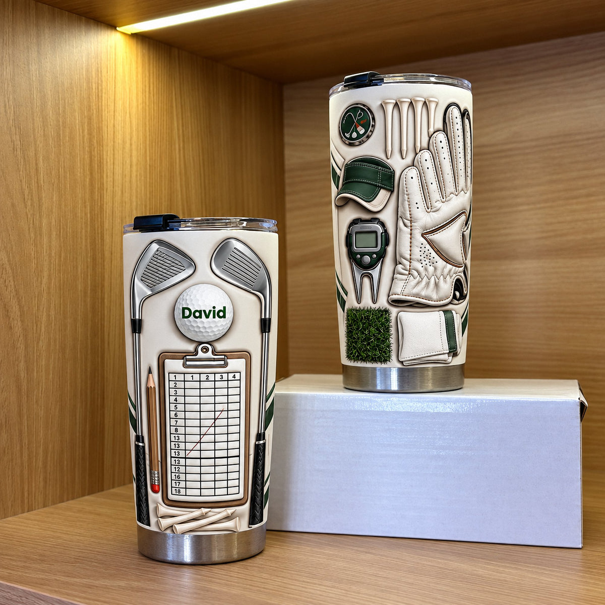 Two insulated golf mugs displaying custom name details, posed on a wooden shelf with warm lighting.