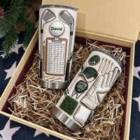 Two personalized golf tumblers packaged in a gift box filled with shredded paper, ready for Dad.