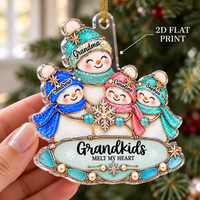 Hand holding a flat single-sided printed acrylic Christmas tree ornament with four snowmen wearing glitter-effect hats and