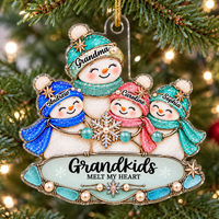 Grandkids Melt My Heart Christmas ornament hanging on a lit pine tree branch with a customized Grandma and three grandchild