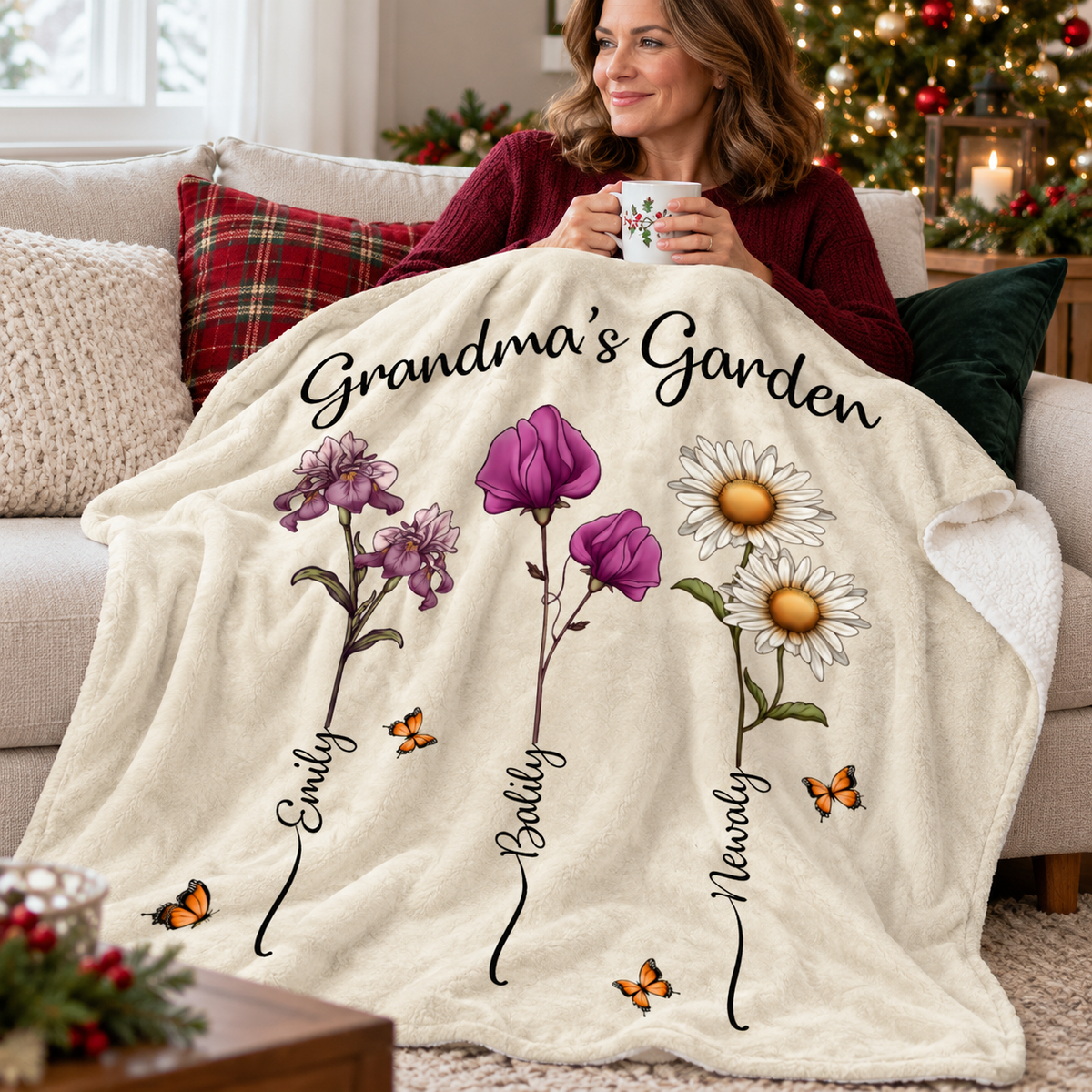 A woman sitting on a cozy couch sipping from a mug under a soft custom name blanket.
