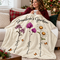 A woman sitting on a cozy couch sipping from a mug under a soft custom name blanket.