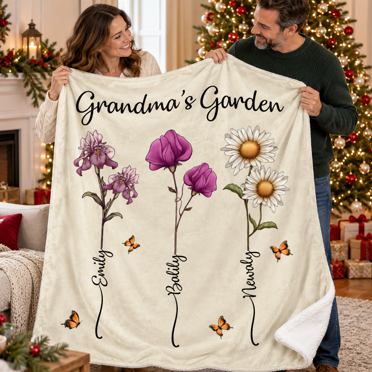A smiling couple holds up a cream-colored custom sherpa blanket featuring Grandma's Garden text, watercolor floral stems, and