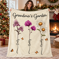 A woman holds up a personalized Grandma's Garden Blanket with watercolor florals by a Christmas tree.