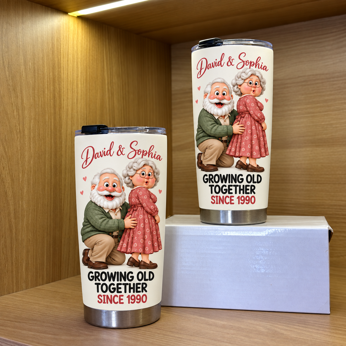 Two white stainless steel travel tumblers featuring an elderly couple illustration and David & Sophia text displayed on a