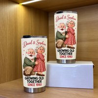 Two white stainless steel travel tumblers featuring an elderly couple illustration and David & Sophia text displayed on a