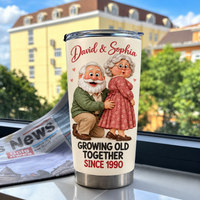 White stainless steel travel tumbler with a cartoon elderly couple illustration and David & Sophia text placed on a ledge