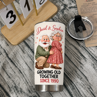 White stainless steel travel tumbler with cartoon elderly couple graphic and David & Sophia text next to its black lid and a
