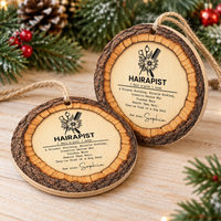 Two hairdresser Christmas gift ornaments displayed on a rustic wood surface with pine.
