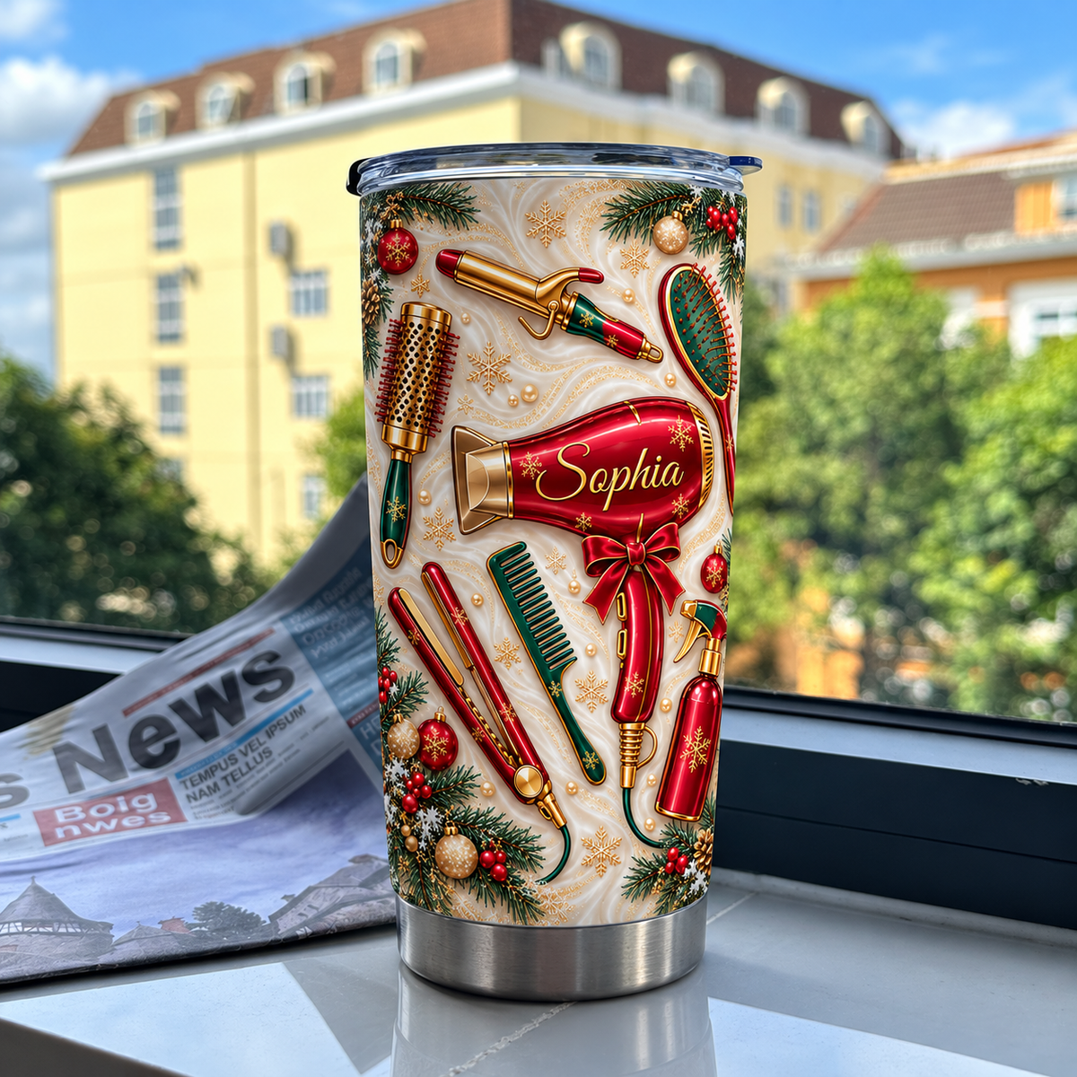 A Christmas hair stylist tumbler with a custom name rests on a windowsill against a backdrop of a yellow building and green