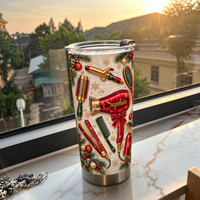 A Christmas hair stylist tumbler featuring red hair tools stands on a sunlit marble windowsill overlooking distant trees and