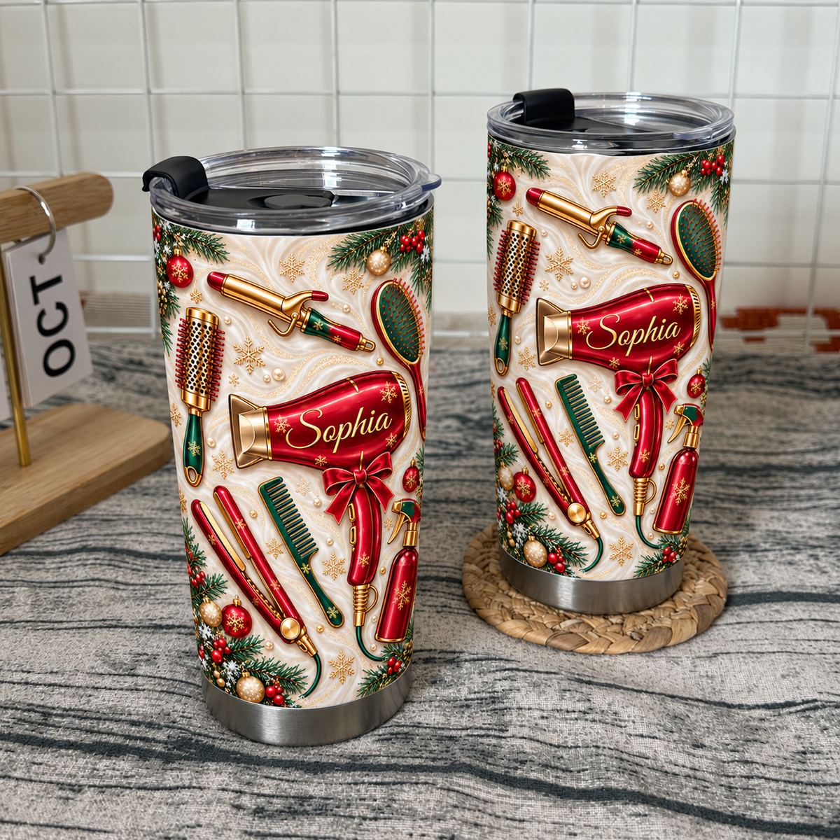 Two custom hairdresser tumblers with a cream swirl background and red styling tools stand on a rustic wooden surface.