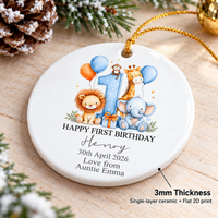 Close-up of the 3-inch double-sided ceramic hanging ornament resting on a wooden surface beside a frosted pinecone.