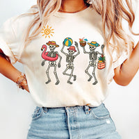 Natural cream t-shirt featuring a playful retro skeleton beach design, worn by a model.