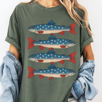 Woman wearing an olive green oversized t-shirt featuring a vintage graphic of four patriotic trout.