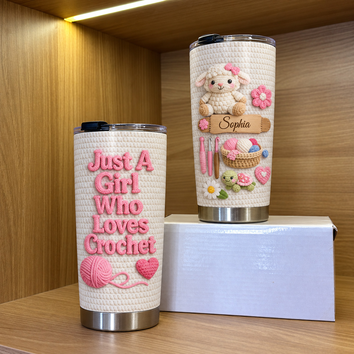 Two personalized insulated stainless steel cups on wooden shelf with gift box, one showing front text and one custom name.