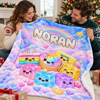 Smiling couple holding a custom kawaii food sherpa throw blanket with pastel cake and the name NORAN printed on it.