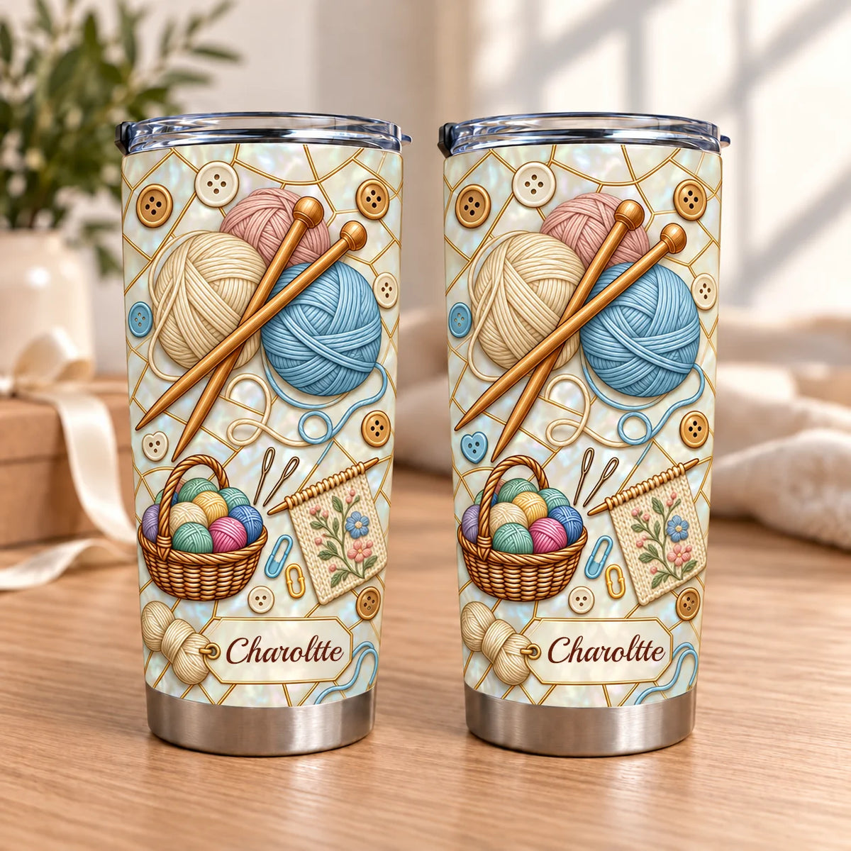 Two insulated stainless steel tumblers featuring knitting yarn patterns with custom name Charoltte, sitting on a wooden