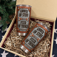 Two custom mechanic tumblers lie nestled in a gift box filled with paper shred next to pine branches.