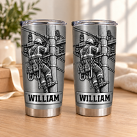 Two stainless steel personalized lineman tumblers with the name William displayed together on a wooden surface.