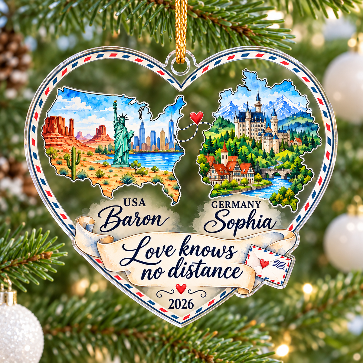 Personalized long distance relationship ornament hanging among pine needles with soft holiday lights bokeh in the background.