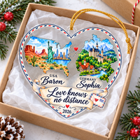 Love Knows No Distance ornament resting inside an open gift box lined with white tissue paper next to pine sprigs.