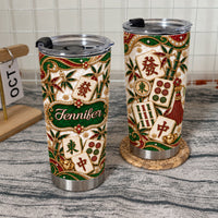 Two stainless steel drinkware tumblers with personalized name banner and mahjong design on textured surface.
