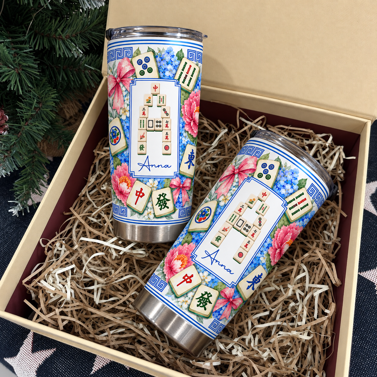 Mahjong Tile Number Floral Tumblers resting inside a gift box filled with paper shred next to miniature tree decor.