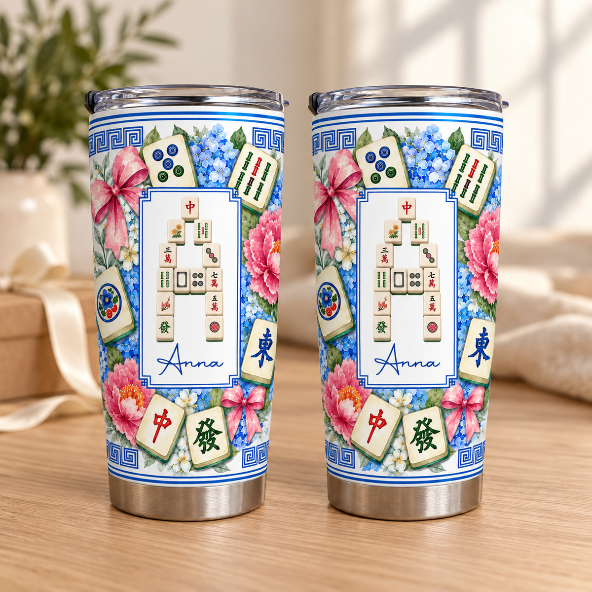 Two custom Mahjong Tile Number Floral Tumblers displayed side by side on a wooden tabletop with soft natural light.